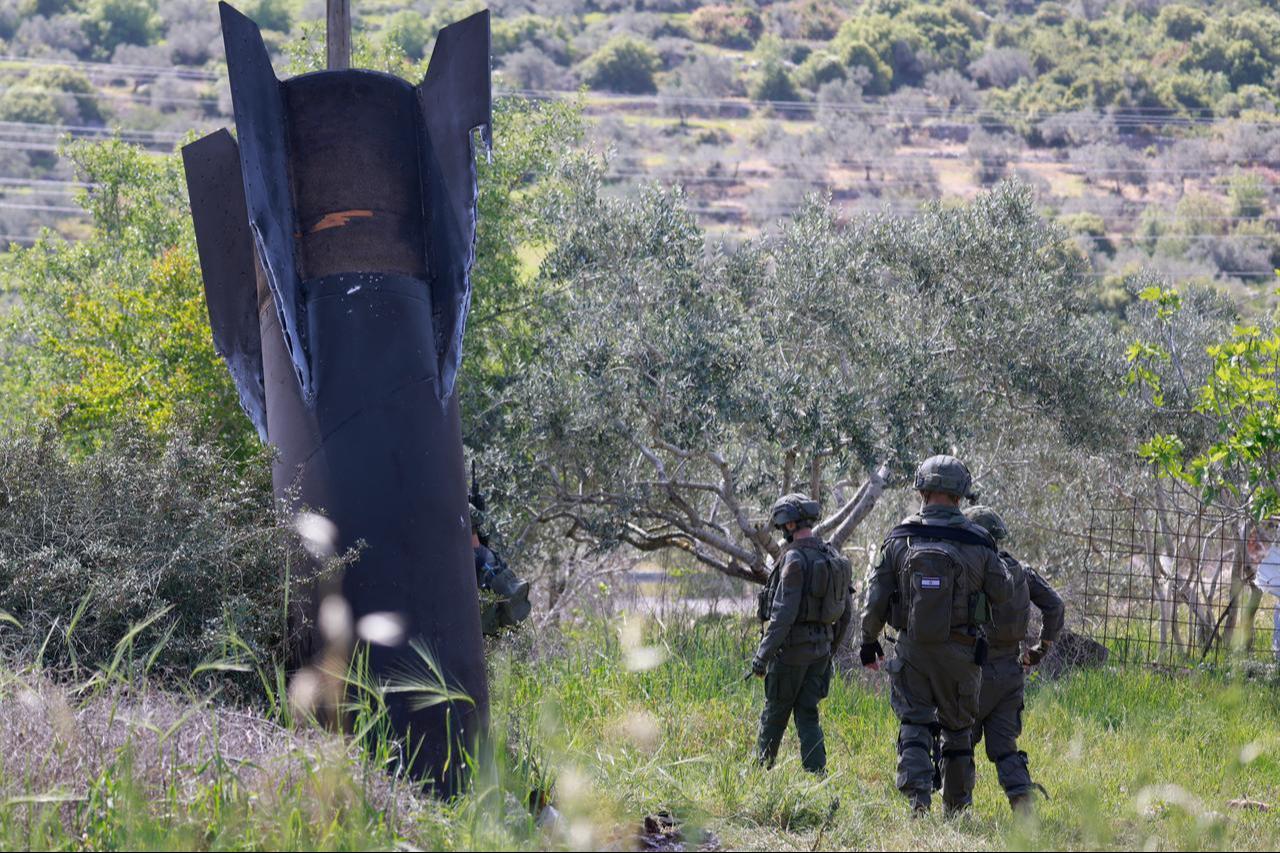 Israeli soldiers check the remnants of an Iranian missile that landed in the Israeli-occupied West Bank village of Hares on March 24, 2026. (AFP Photo)