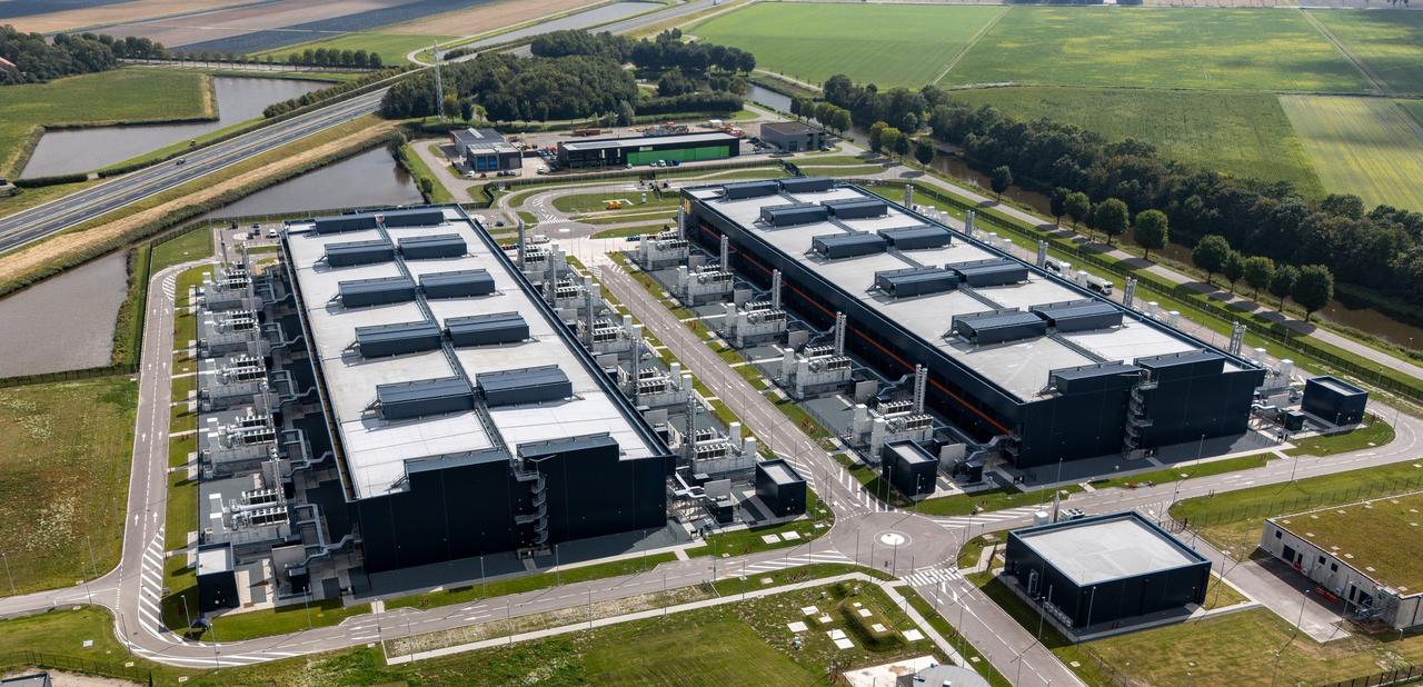 An aerial view of a large data center complex surrounded by farmland and waterways. (Adobe Stock Photo)