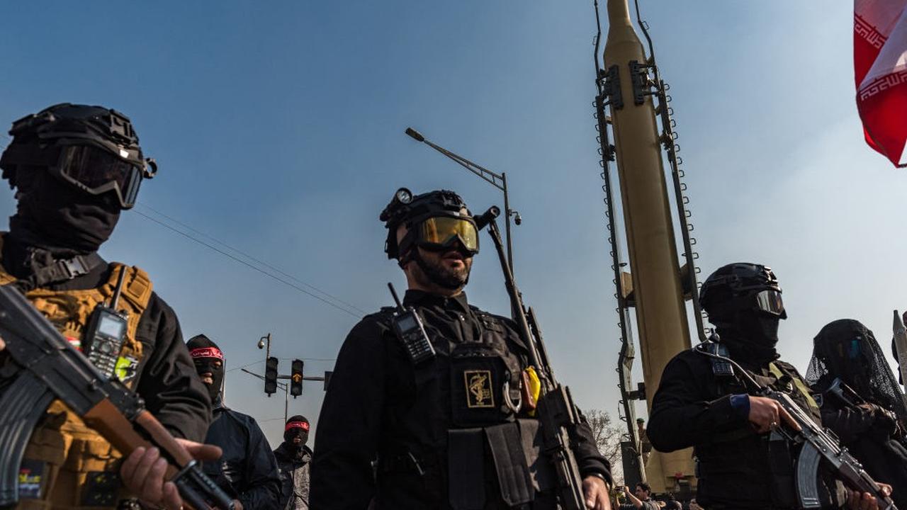 Masked and goggled Iranian Basij militants and IRGC personnel carry AK-47s during a parade in downtown Tehran, Iran, on January 10, 2025. (AFP Photo)