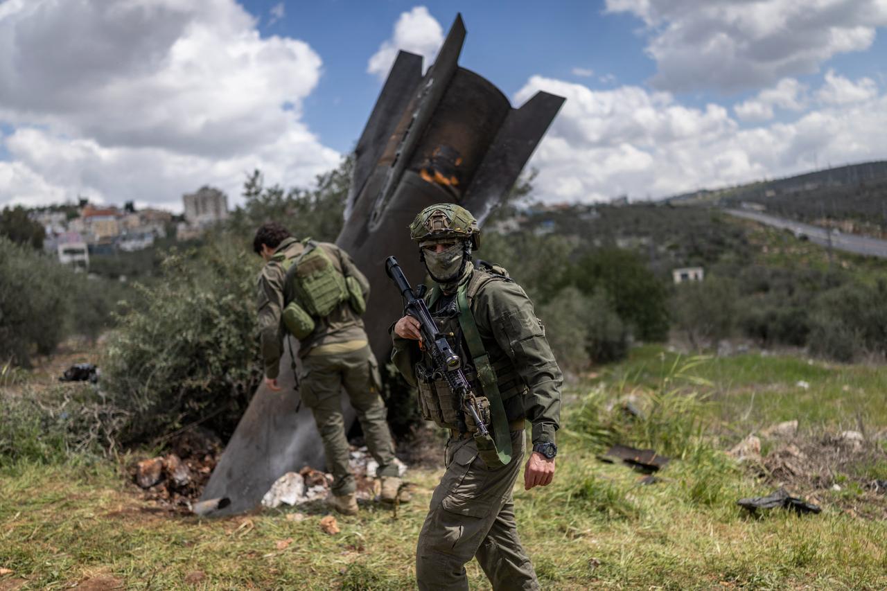 Israeli soldiers arrive to check an Iranian missile remnant that landed in the Israeli-occupied West Bank village of Hares on March 24, 2026. (AFP Photo)