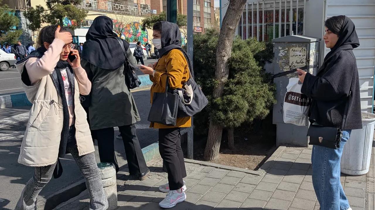 Iranians try to clear a street amid heavy traffic in Tehran, Iran, Feb. 28, 2026. (AFP Photo)