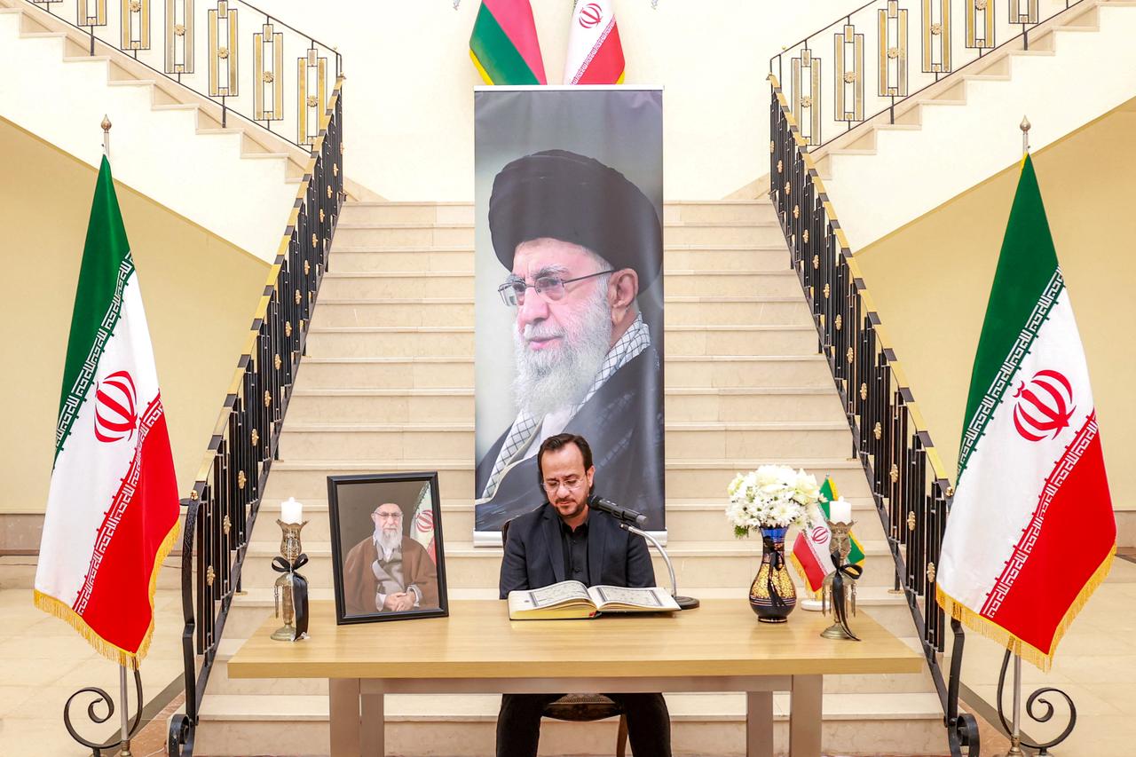 A man reads verses from the Qur'an, Islam's holy book, as mourners gather to pay their respects for Iran's slain supreme leader Ali Khamenei, who was was killed in a joint US-Israeli strike on Tehran on February 28. (AFP Photo)