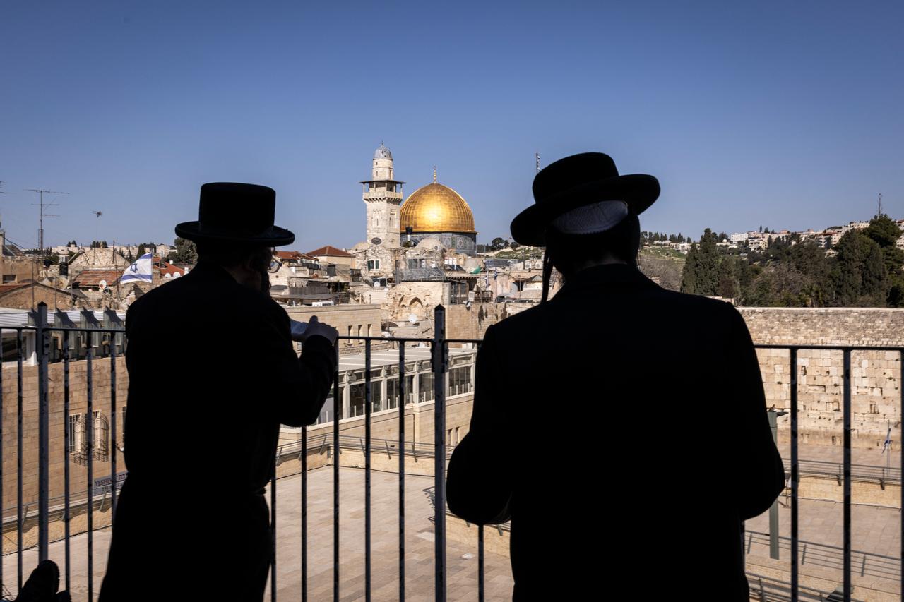 Jewsih ultra-Orthodox men pray outside the closed Western Wall, as they face Islam's Dome of the Rock, in the Old city of Jerusalem on March 2, 2026. (AFP Photo)