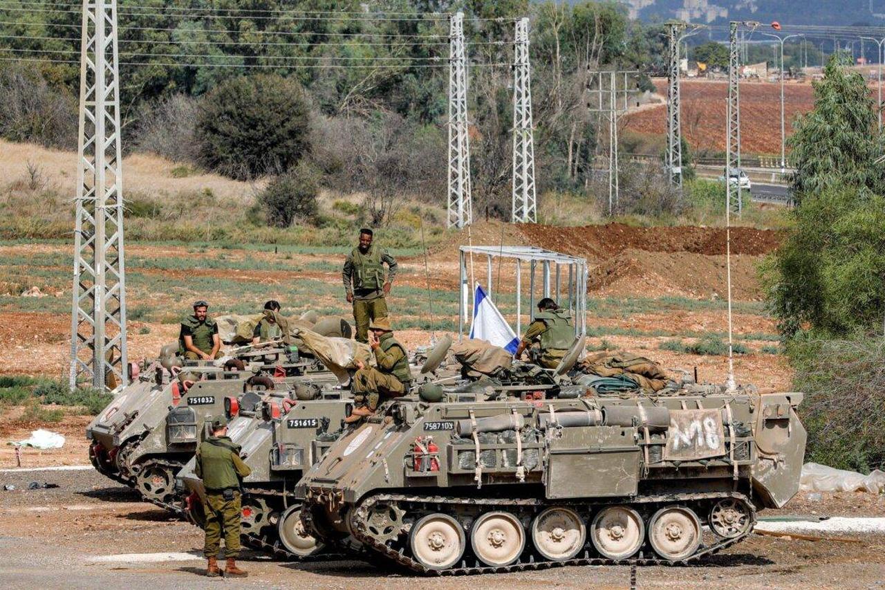 Israeli army soldiers gather by three tracked medical vehicles near the northern town of Kiryat Shmona, close to the border with Lebanon, on October 31, 2023. (AFP Photo)