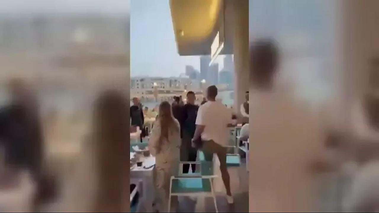 Diners react inside a Dubai restaurant as the sound of a traditional Ramadan iftar cannon triggers panic, with some guests attempting to flee or take cover amid fears of a missile strike. (Photo via X)