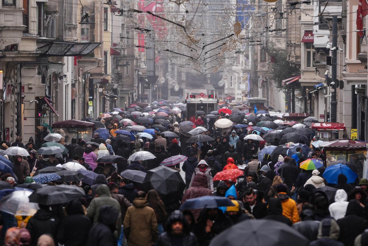 A crowded Istiklal Avenue fills with pedestrians carrying umbrellas as rainfall affects daily life in Istanbul, Türkiye, March 21, 2026. (AA Photo)