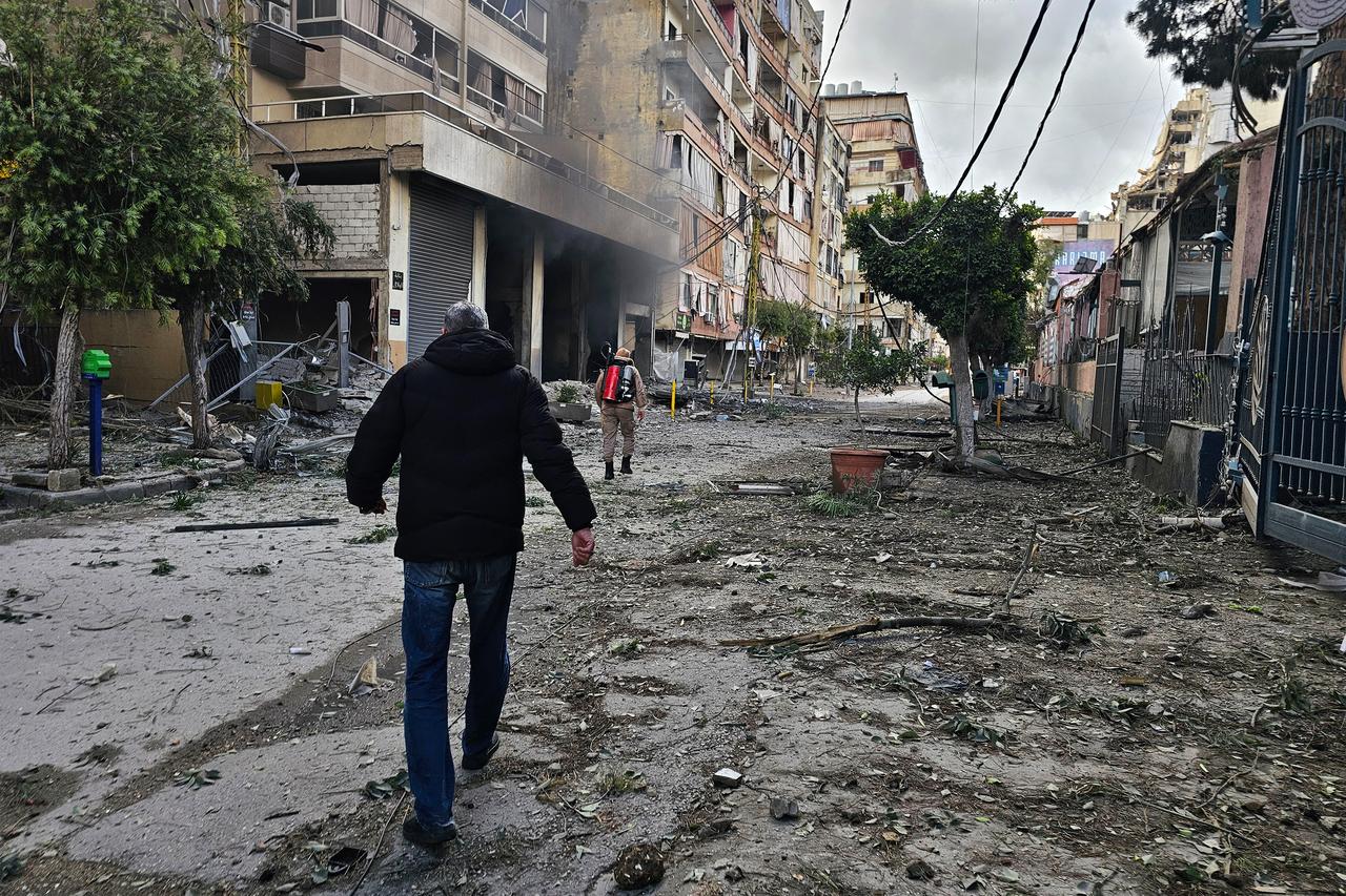 Firefighters inspect the site of an overnight Israeli airstrike on the Haret Hreik neighbourhood in Beirut's southern suburbs on March 30, 2026. (AFP Photo)