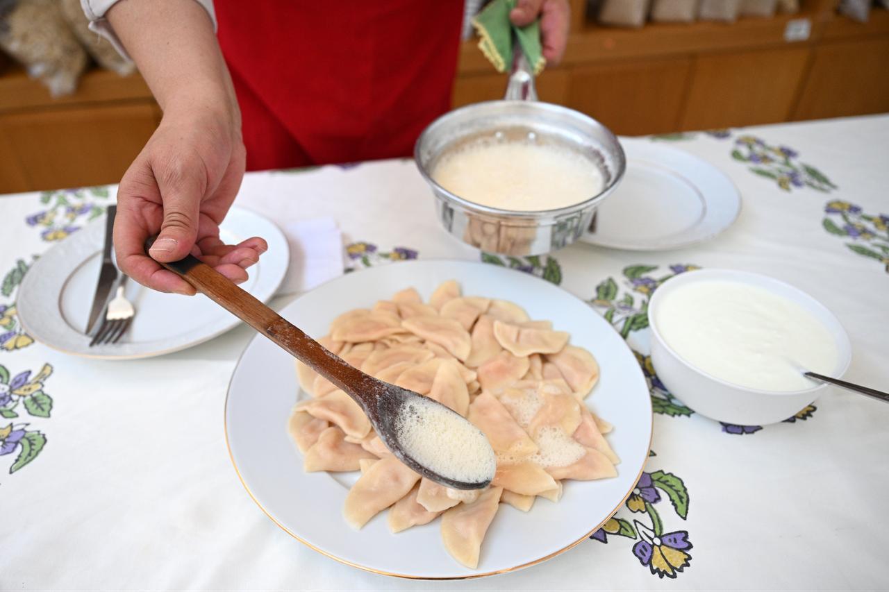 Melted butter is poured over freshly cooked hingel dumplings before serving in Sivas, Türkiye, March 4, 2026. (AA Photo)