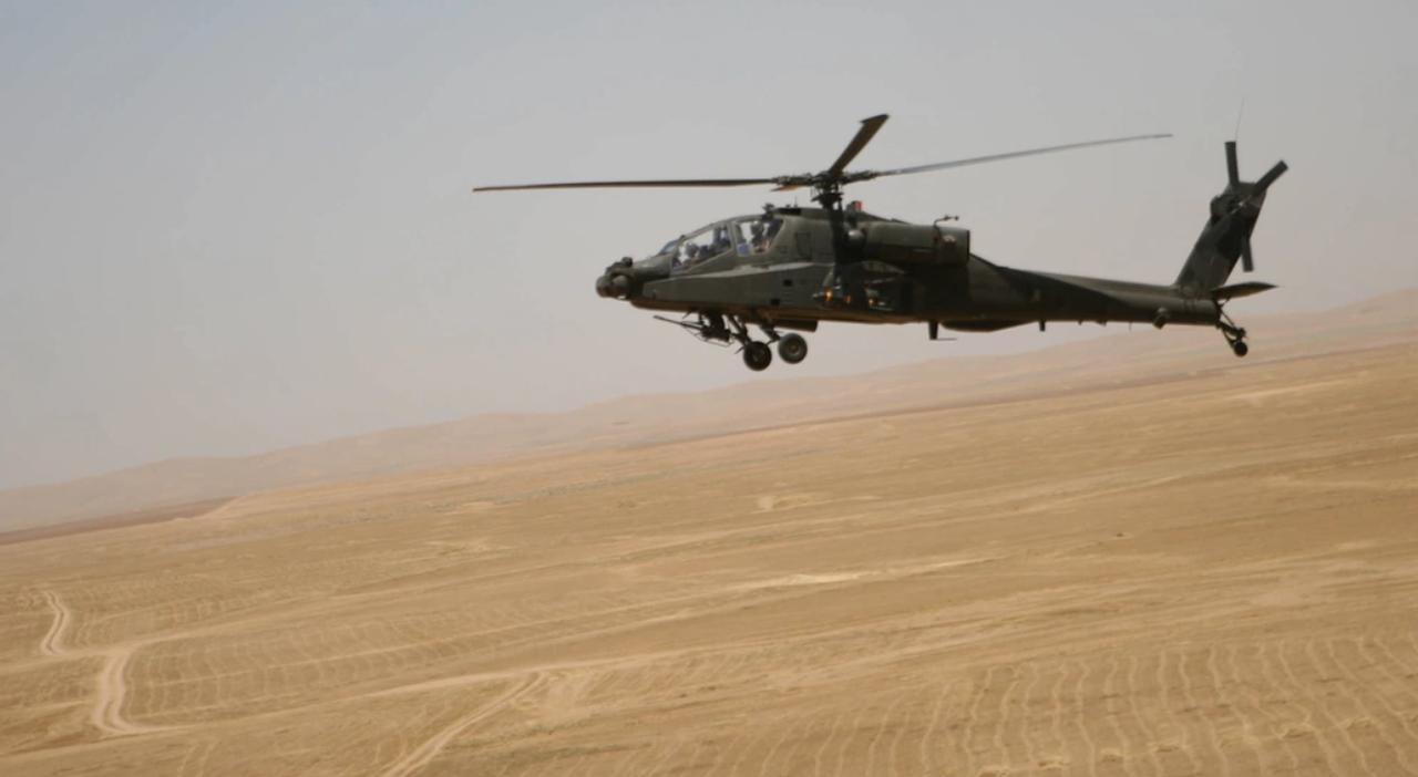 AH-64D Apache Longbow attack helicopter flies over the desert terrain between Tall'Afar and Mosul, Iraq, June 14, 2006. (Photo via DVIDS)