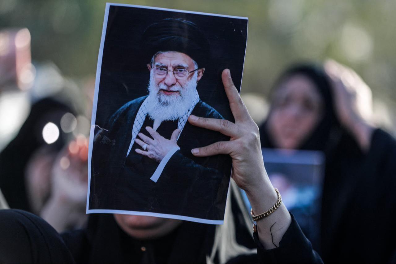 An Iraqi Shiites Muslim woman holds up the image of killed Iranian supreme leader Ali Khamenei, during a symbolic funeral the day after his assassination, in the district of Sadr City, in Baghdad, Iraq on March 1, 2026. (AFP Photo)