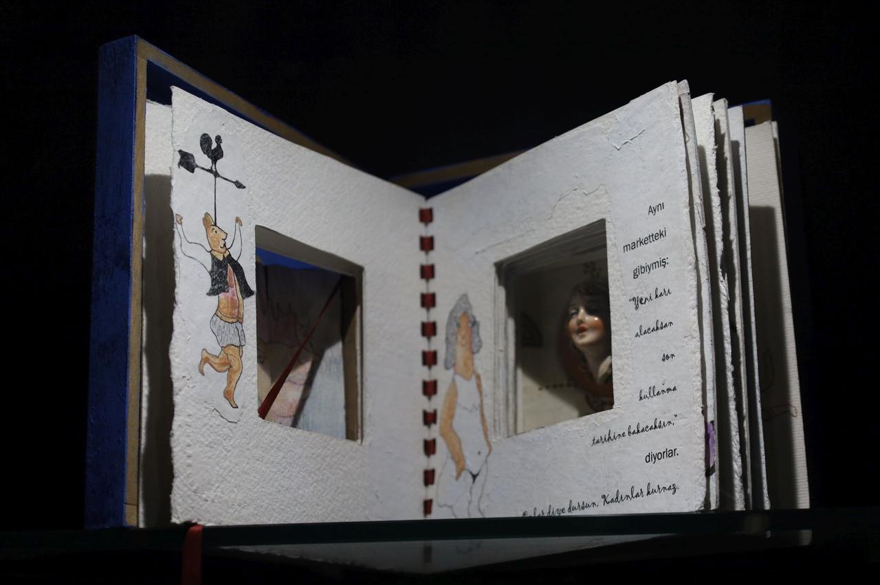 An artistic handmade book featuring illustrated pages is exhibited at the Paper and Book Arts Museum at Ege University in Izmir, Türkiye.  (IHA Photo)