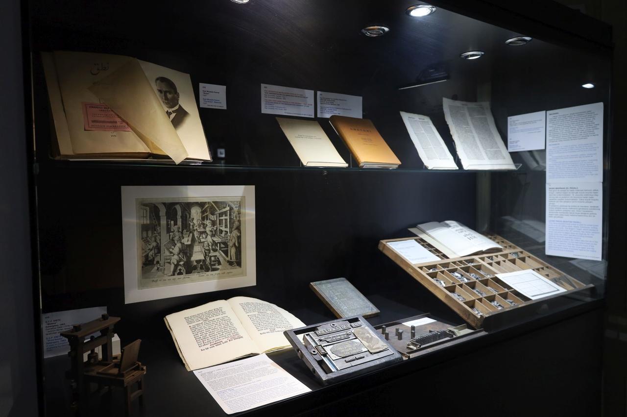 Historical printing materials, books and illustrations are displayed in a showcase at the Paper and Book Arts Museum at Ege University in Izmir, Türkiye. (IHA Photo)