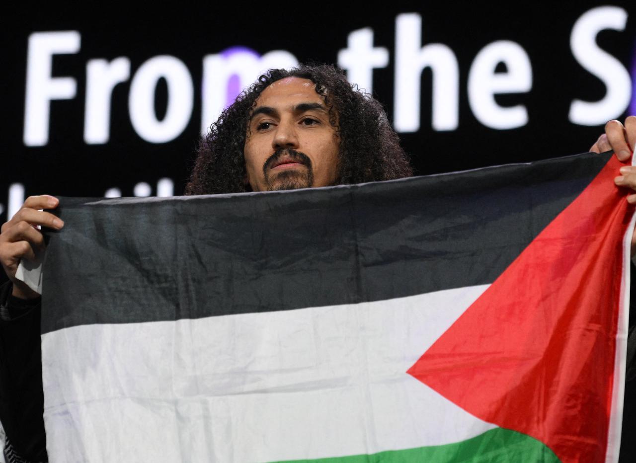 Syrian-Palestinian director Abdallah Alkhatib stands on stage as he accepts an award for “Chronicles From the Siege” at Berlinale, Berlin, Germany, February 21, 2026. (AFP Photo)