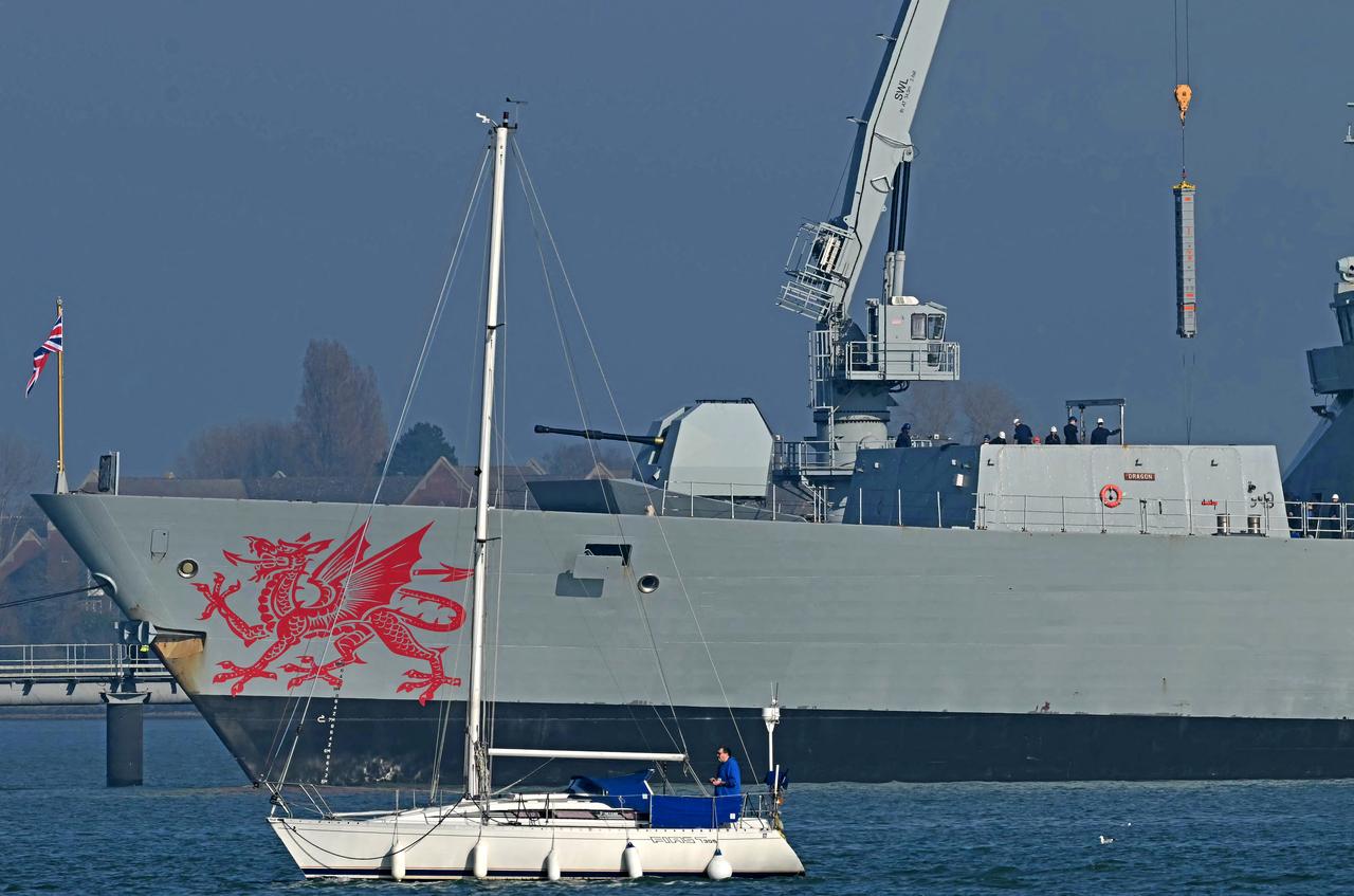 Goods are loaded onto HMS Dragon, a Royal Navy Type 45 Daring-class air-defence destroyer warship, moored at the HMNB Portsmouth Upper Harbour Ammunition Facility (UHFC), outside HM Naval Base Portsmouth, on the south coast of England, March 4, 2026. (AFP Photo)