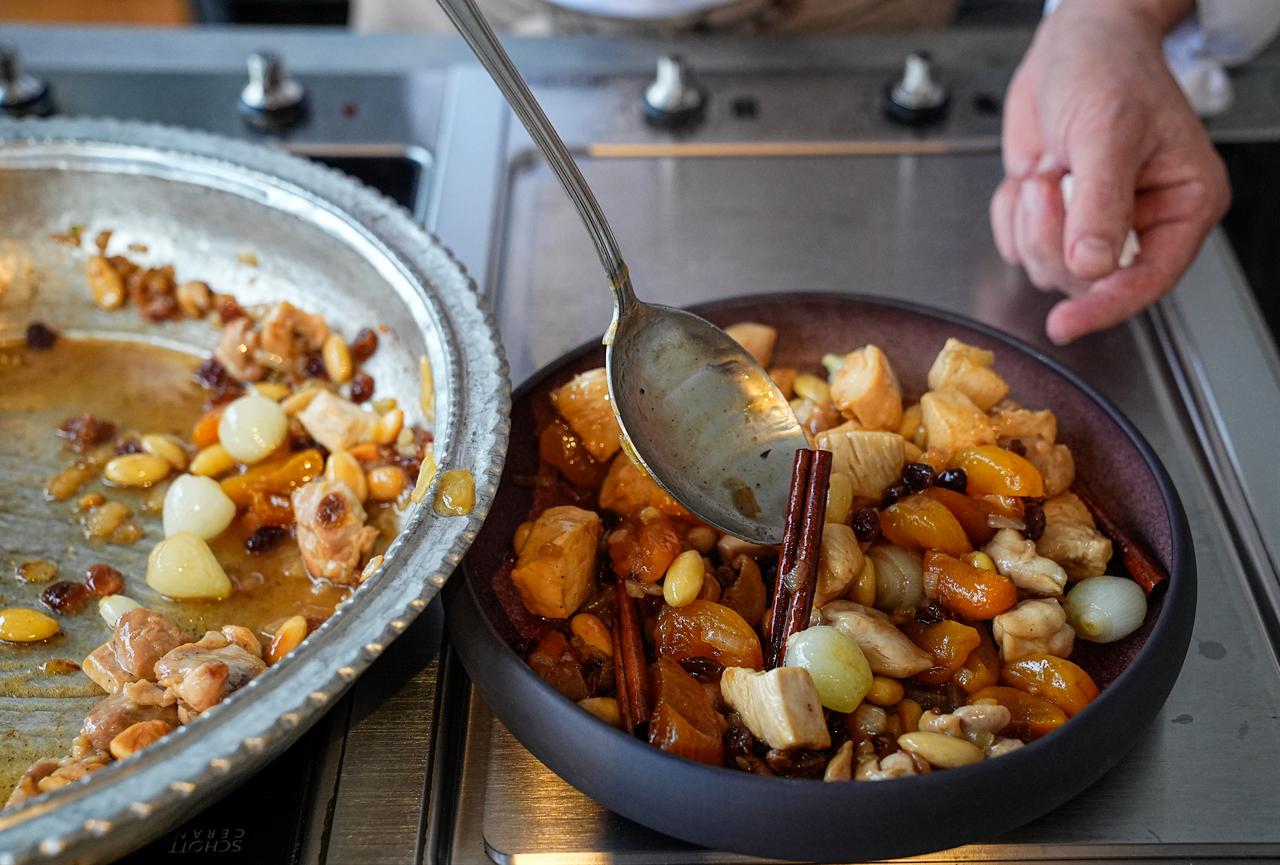 Chef Birkan Erkoylu plates the finished honeyed Mahmudiye dish after cooking, presenting the sweet and savory Ottoman recipe in Istanbul, Türkiye, March 4, 2026. (AA Photo)