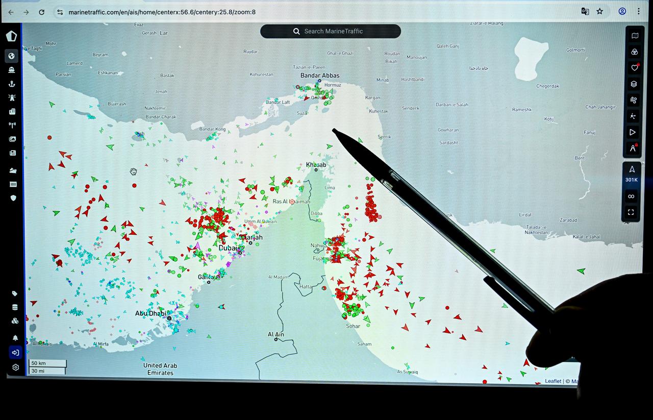 A person points at a page on the Marinetraffic website that shows commercial boat traffic on the edge of the Strait of Hormuz near the Iranian coast, in Paris, March 4, 2026. (AFP Photo)