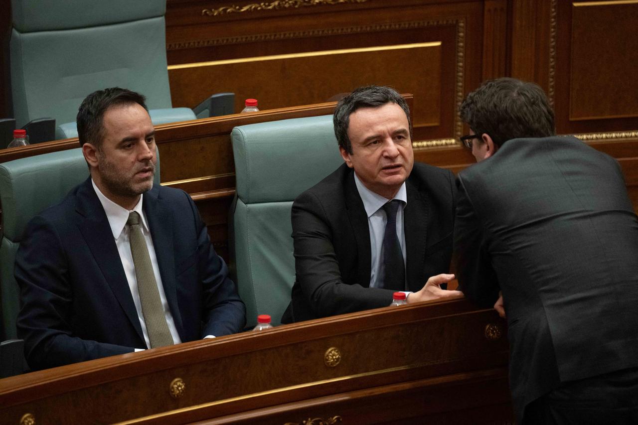 Kosovo Prime Minister Albin Kurti (C) flanked by presidential nominee Glauk Konjufca (L) attends a parliamentary session in Pristina on March 5, 2026, as members of Parliament fail to elect a new president. (AFP Photo)