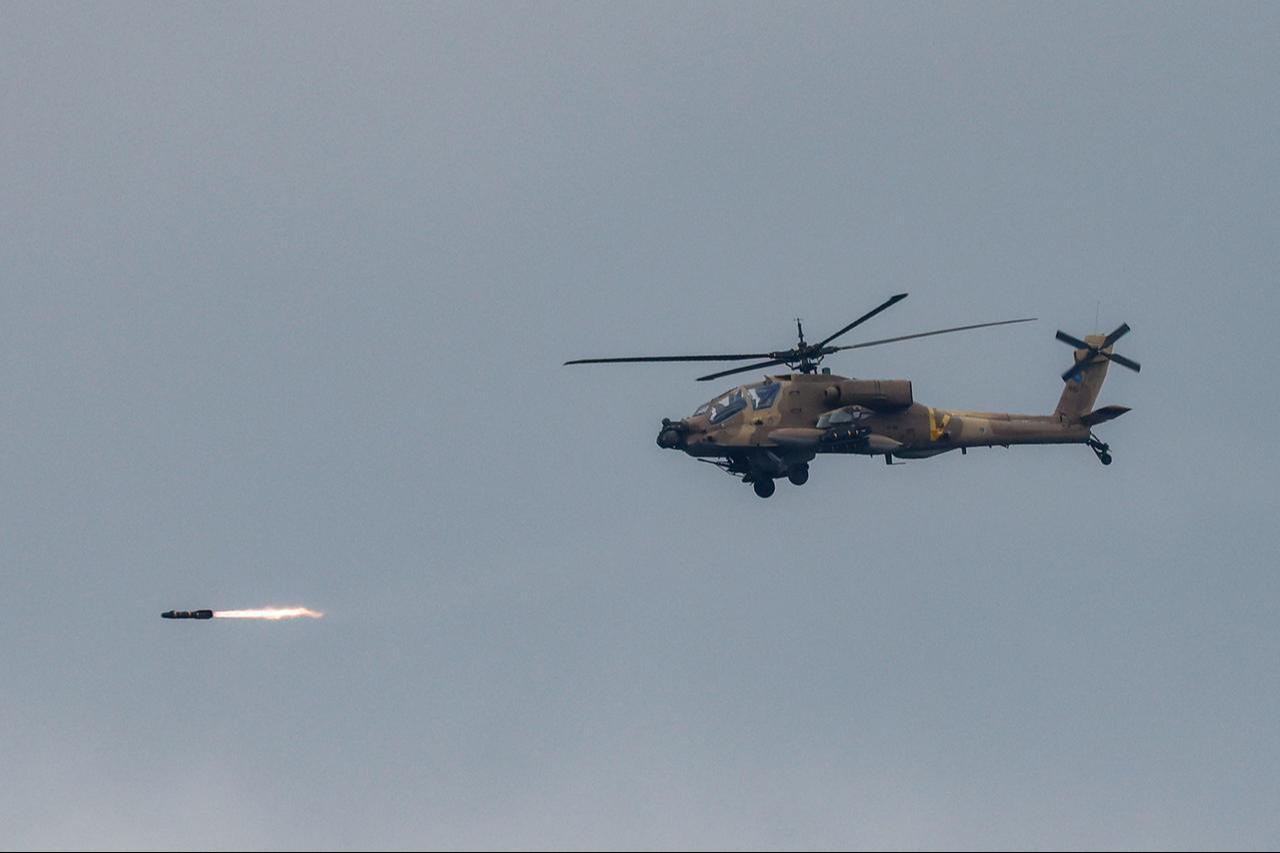 An Israeli Air Force AH-64 Apache attack helicopter fires a missile while flying at a position along the border between northern Israel and southern Lebanon on March 4, 2026. (AFP Photo)