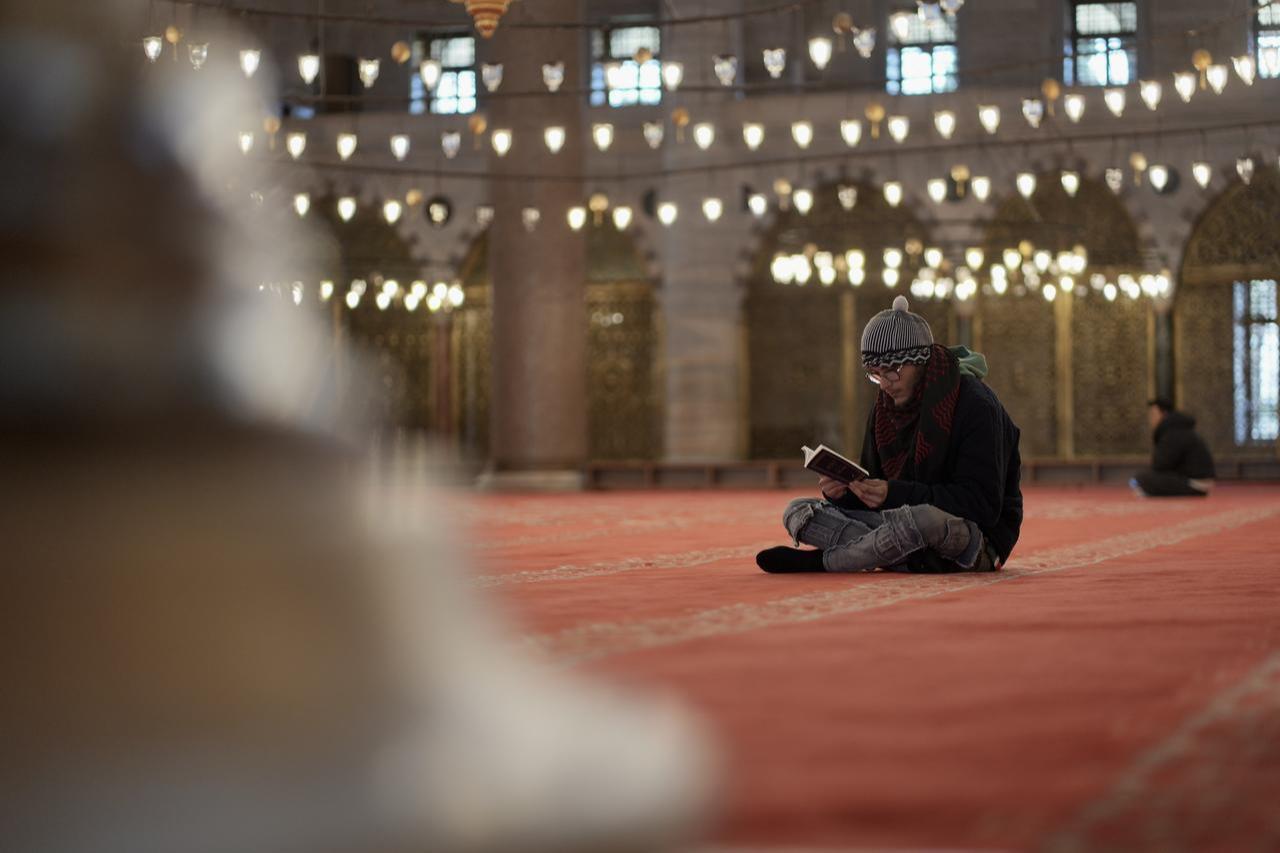 Adria Calafell, a Spanish citizen, reads the holy Quran inside a mosque after converting to Islam in Istanbul, Türkiye, on February 27, 2026. (AA Photo)