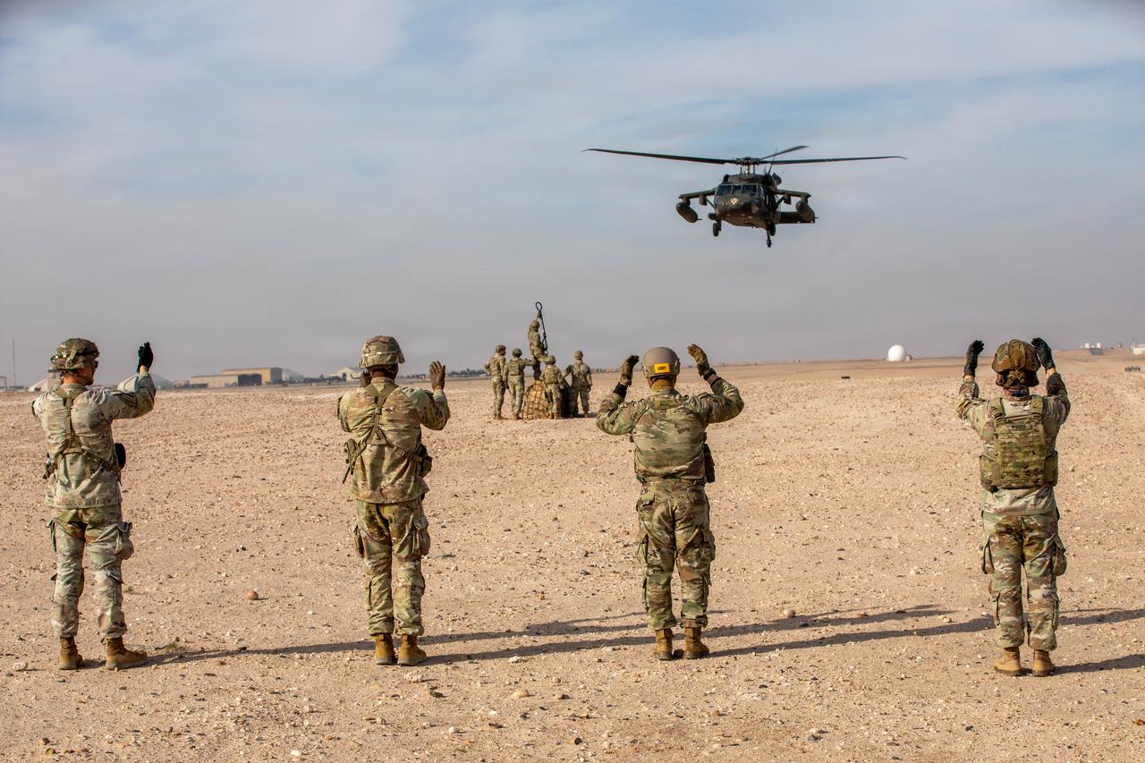 Soldiers guide in a UH-60 Blackhawk for landing using hand and arm signals during a field training exercise in U.S. Central Command area of responsibility, Jan. 27, 2026. (Photo via U.S. Army)