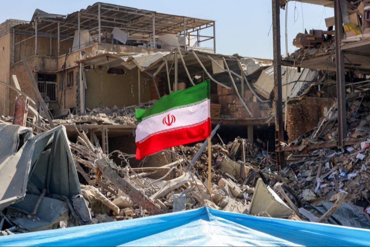 An Iranian flag is placed amids rubble and debris next to a destroyed residential building near Ferdowsi square in Tehran, Iran on March 3, 2026. (AFP Photo)