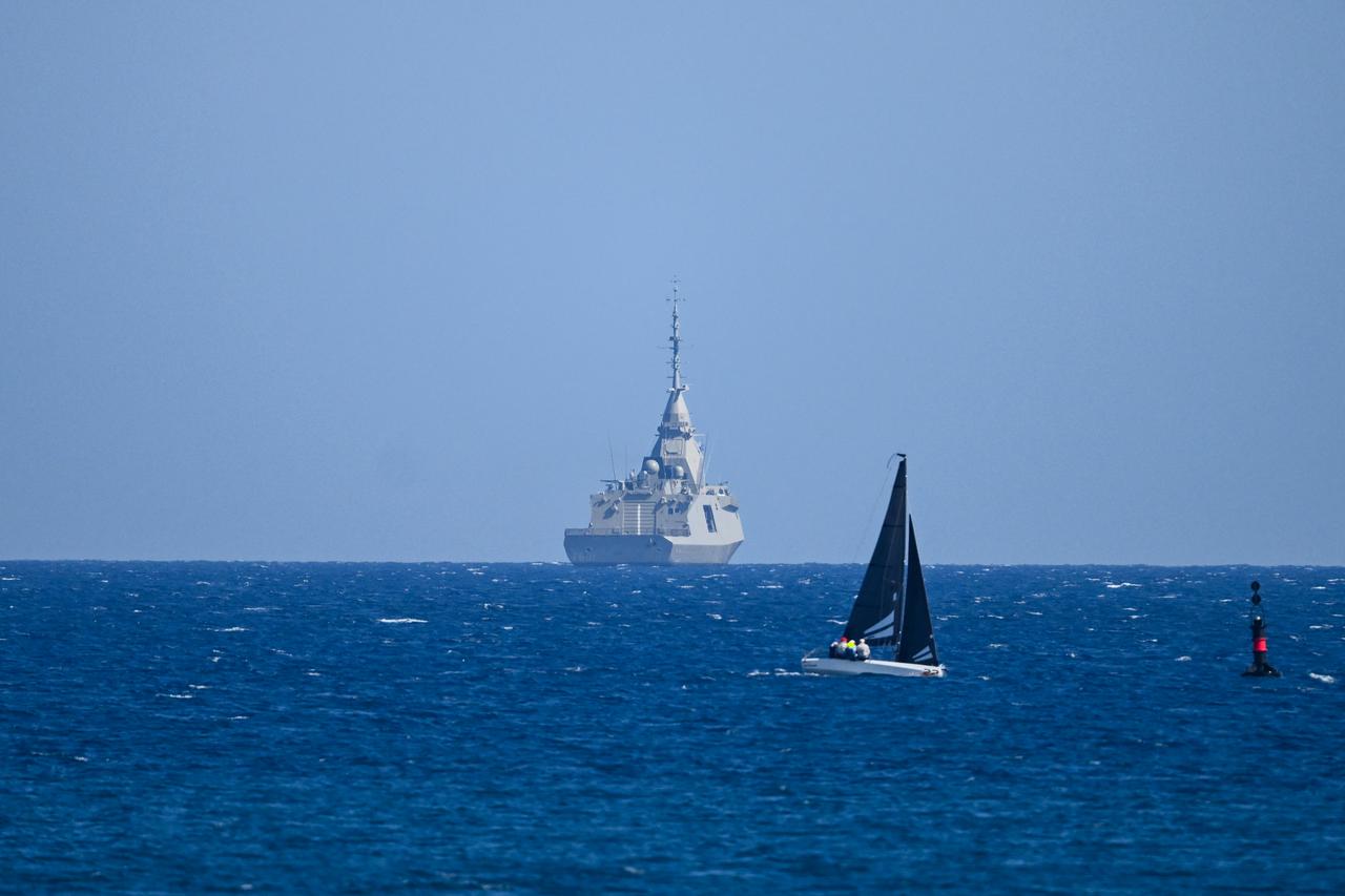 A sailboat sails past the Greek frigate Keimon at sea off Limassol on March 4, 2026. (AFP Photo)