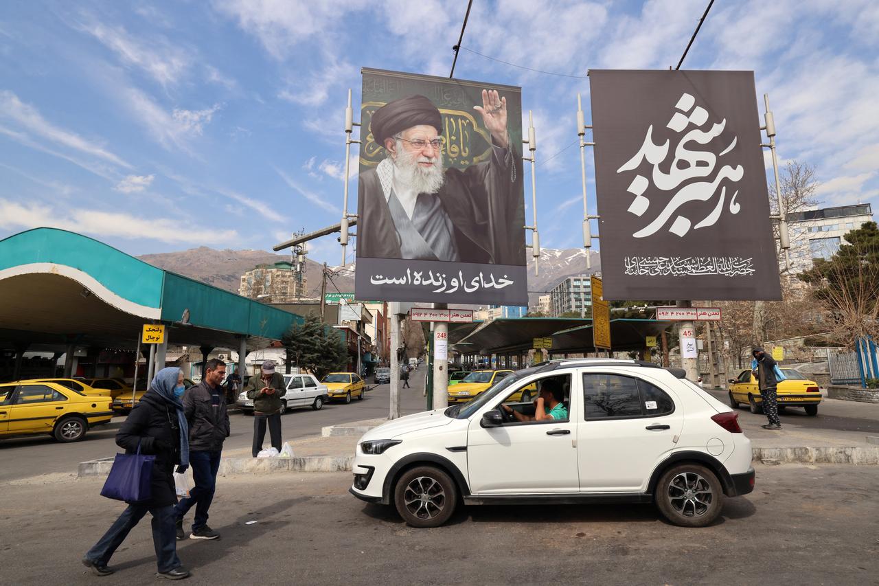 A large banner with the image of Iran's slain supreme leader Ali Khamenei adorns a main taxi rank close to Tajrish Square, in Tehran on March 7, 2026. (AFP Photo)