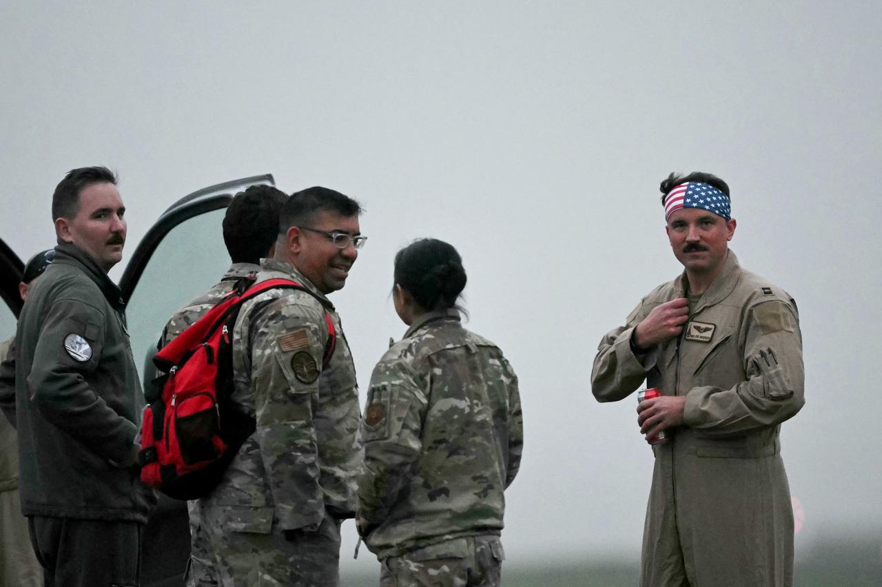 US Military personnel wait to enter a vehicle after disembarking from a US Air Force B-1 Lancer bomber at RAF Fairford in southwest England shortly after sunrise, March 7, 2026. (AFP Photo)