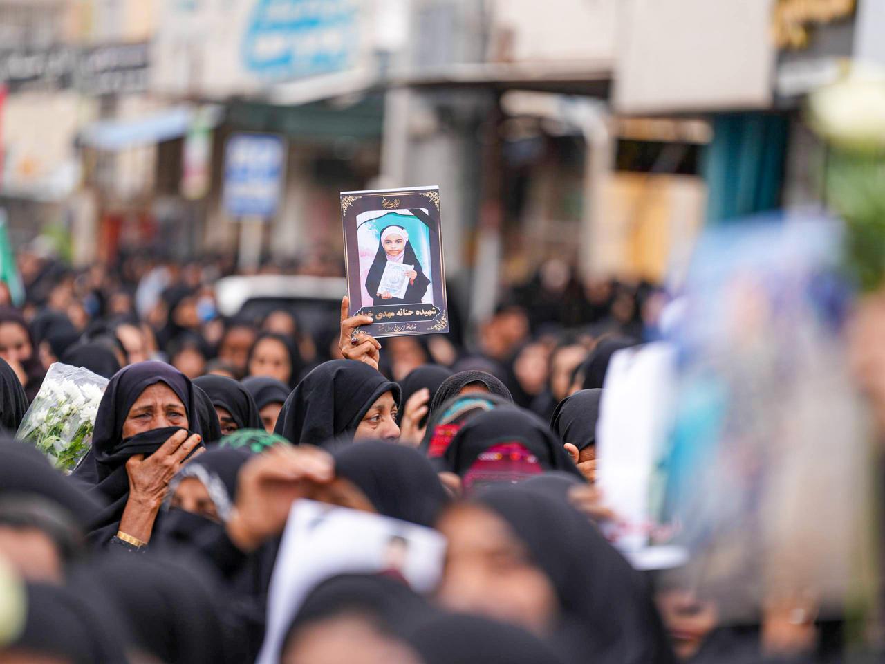 Mourners hold a portrait of a student during a funeral ceremony for children, who lost their lives after a primary school in Iran’s Hormozgan province was targeted in US and Israeli attacks, March 3, 2026 in Minab, Iran. (AA Photo)