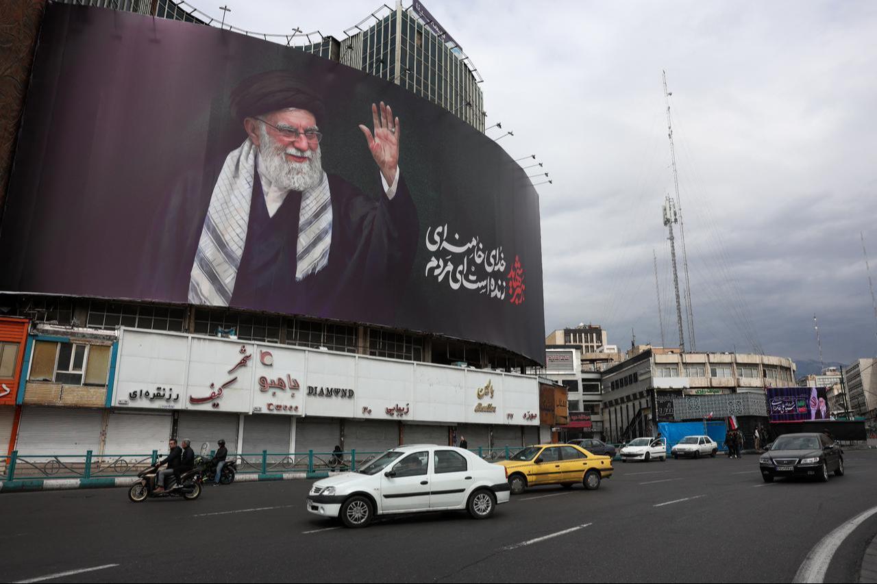 Motorists drive past a billboard of Iran's late supreme leader, Ali Khamenei, who was killed in an airstrike on Feb. 28, 2026, in Tehran, Iran on March 2, 2026. (AFP Photo)