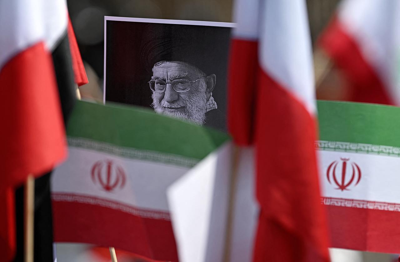 A protestor holds a placard with an image of the late Iranian Supreme Leader Ali Khamenei surrounded by Iranian flags outside the US consulate in Mexico City, Mexico on March 7, 2026. (AFP Photo)