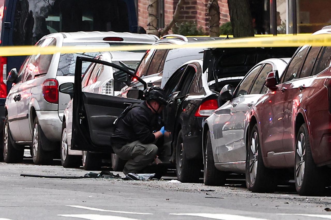 A NYPD bomb squad officer checks the inside of a car on the Upper East Side of Manhattan after a homemade explosive device that failed to detonate, in New York, United States, March 8, 2026. (AFP Photo)