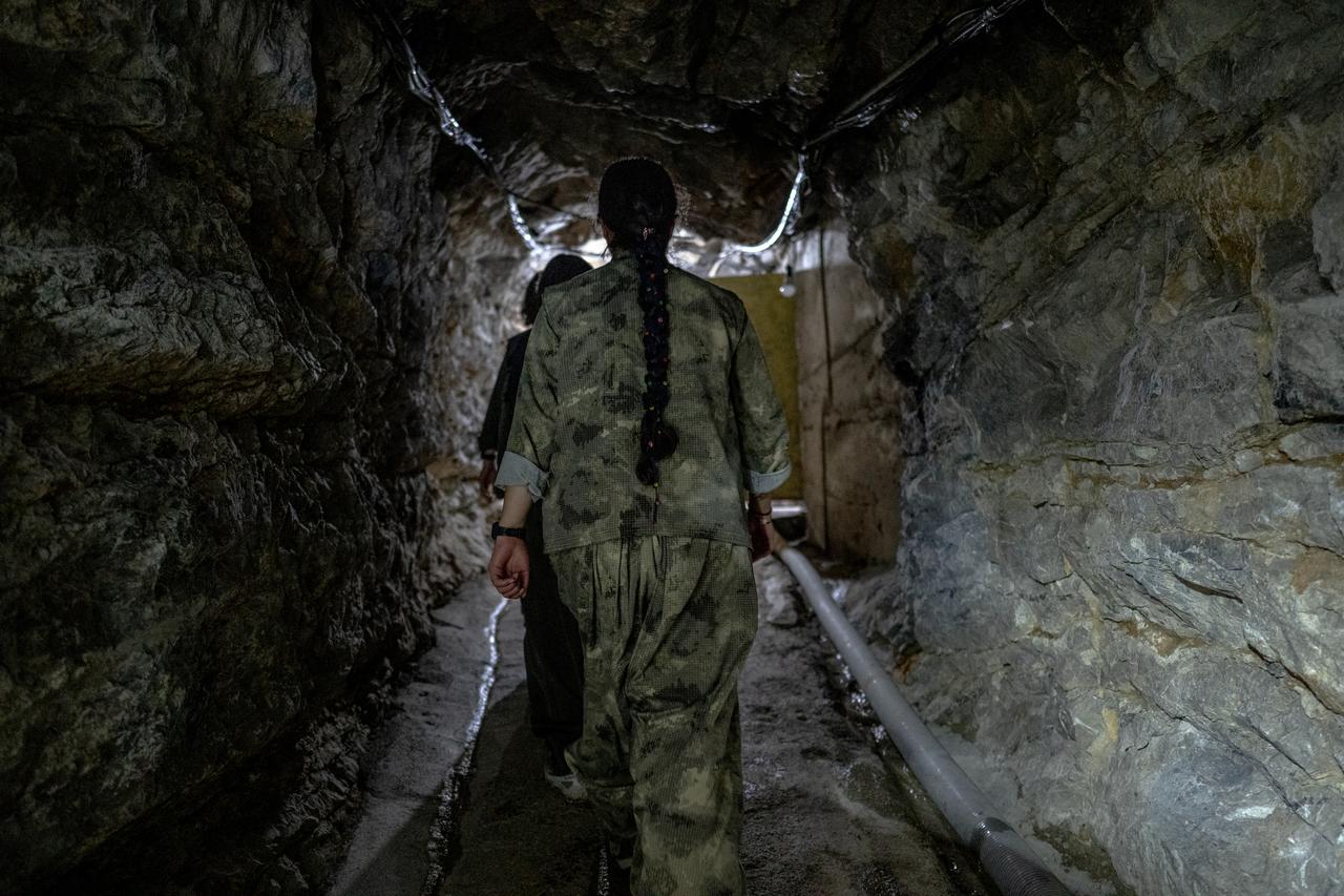 Kurdish armed group members from the Iranian Kurdish armed faction PJAK walk inside a tunel at a site near the Iraqi border with Iran in Iraq's northern autonomous Kurdish region, on March 8, 2026. (AFP Photo)