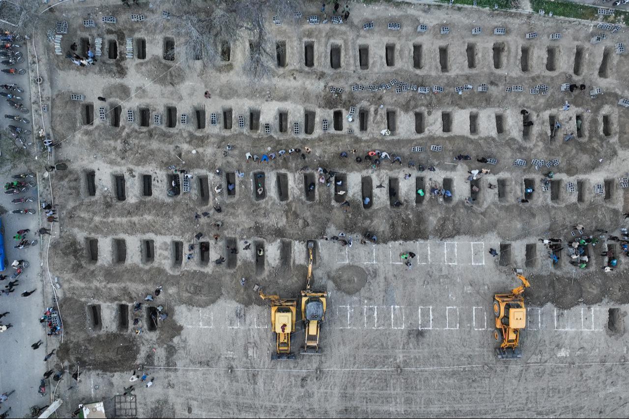Mourners dig graves during the funeral for children killed in a reported strike on a primary school in Iran’s Hormozgan province in Minab on March 3, 2026. (Photo by Iranian Press Center/AFP)