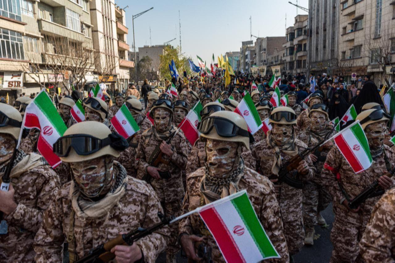 Masked Basiji militants march while holding AK-47 rifles during a parade of an alleged 110,000 paramilitary Basij and IRGC forces in downtown Tehran, Iran, on Jan. 10, 2025. (AFP Photo)