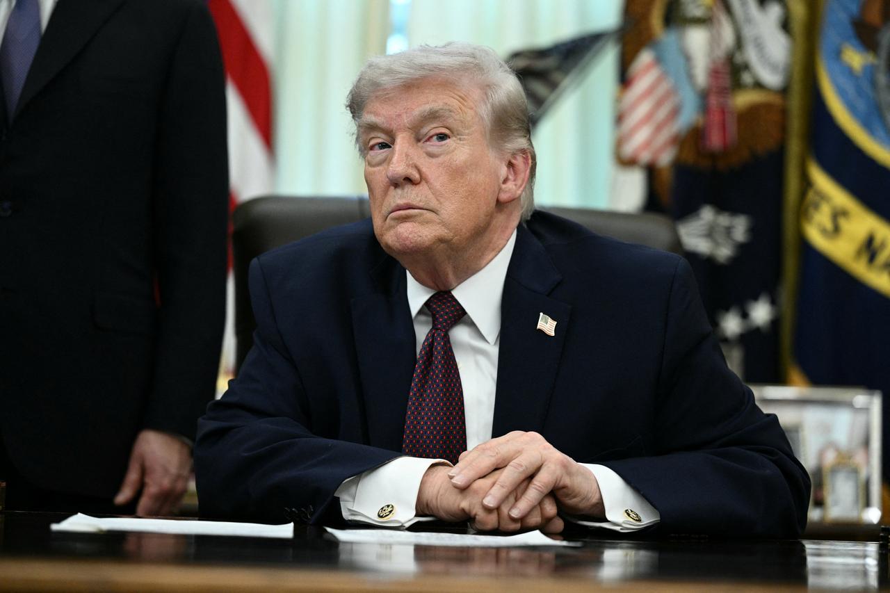 US President Donald Trump takes a question from a reporter after signing an executive order in the Oval Office of the White House in Washington, DC, on March 31, 2026. (AFP Photo)
