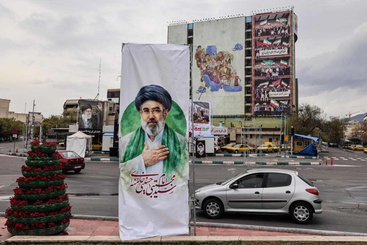 Motorists drive past a banner depicting Iran's new supreme leader, Mojtaba Khamenei, in Tehran on March 31, 2026. (AFP Photo)