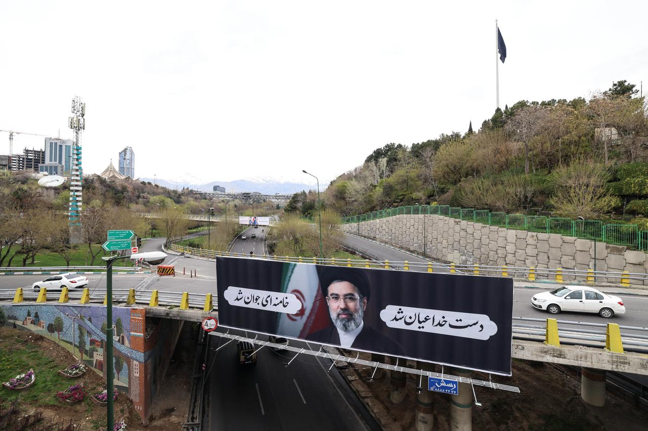 Motorists drive past a billboard depicting Iran's new supreme leader, Mojtaba Khamenei, in Tehran on March 31, 2026. (AFP Photo)