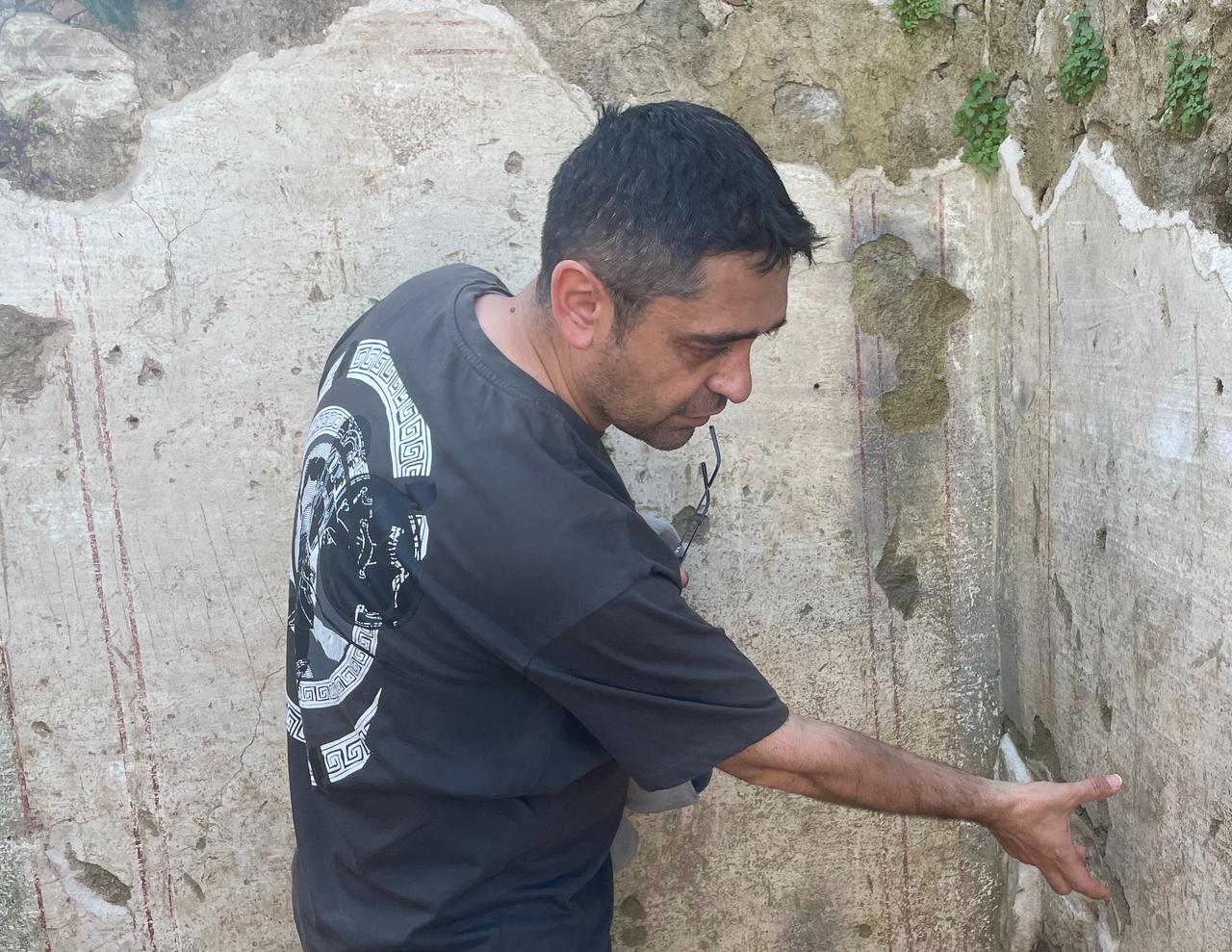 Excavation Deputy Head Tolga Candur examines architectural remains in Aspendos, Antalya, Türkiye, April 8, 2026. (Photo by Koray Erdogan/Türkiye Today)