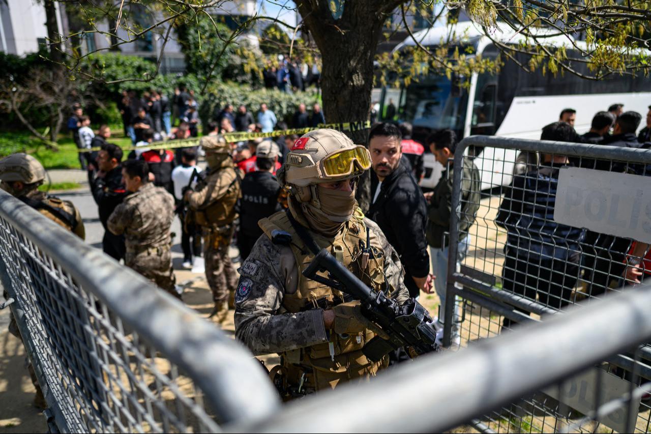A police officer stands alert near the Israeli Consulate in Istanbul on April 7, 2026, following a shootout between gunmen and police. (AFP Photo)