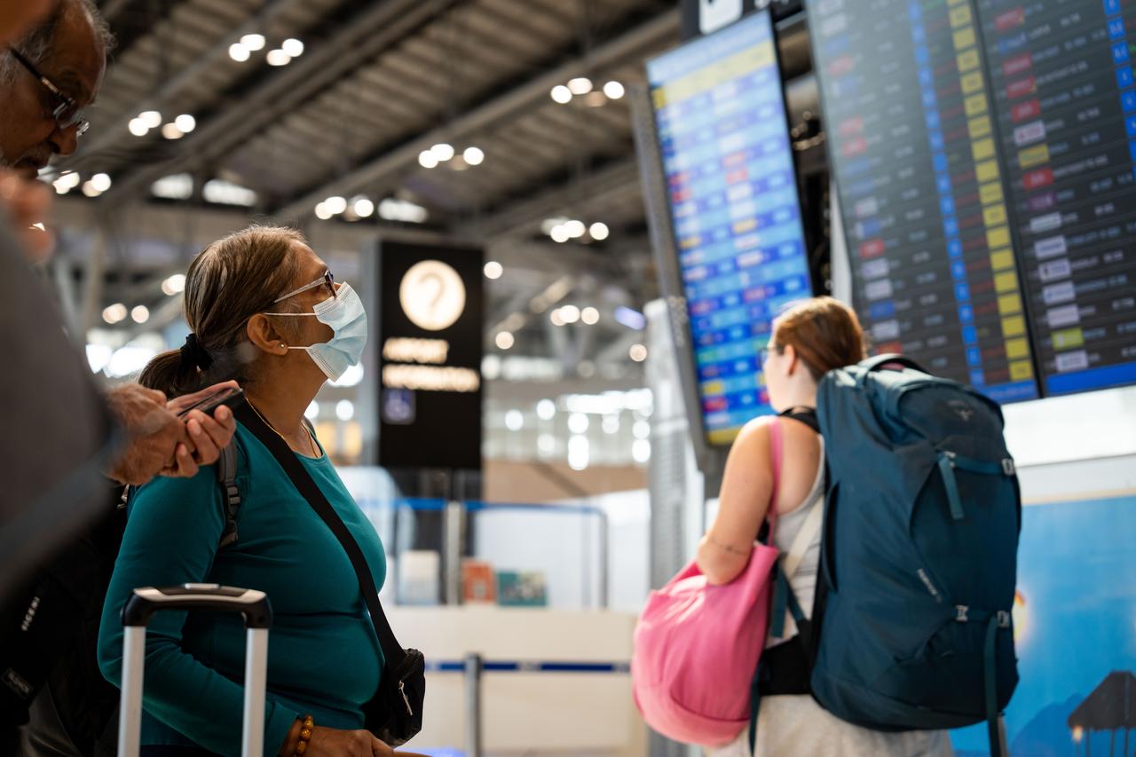 A traveler wearing a protective face mask checks departure times at Suvarnabhumi Airport in Bangkok, Thailand on January 29, 2026. (AA Photo)