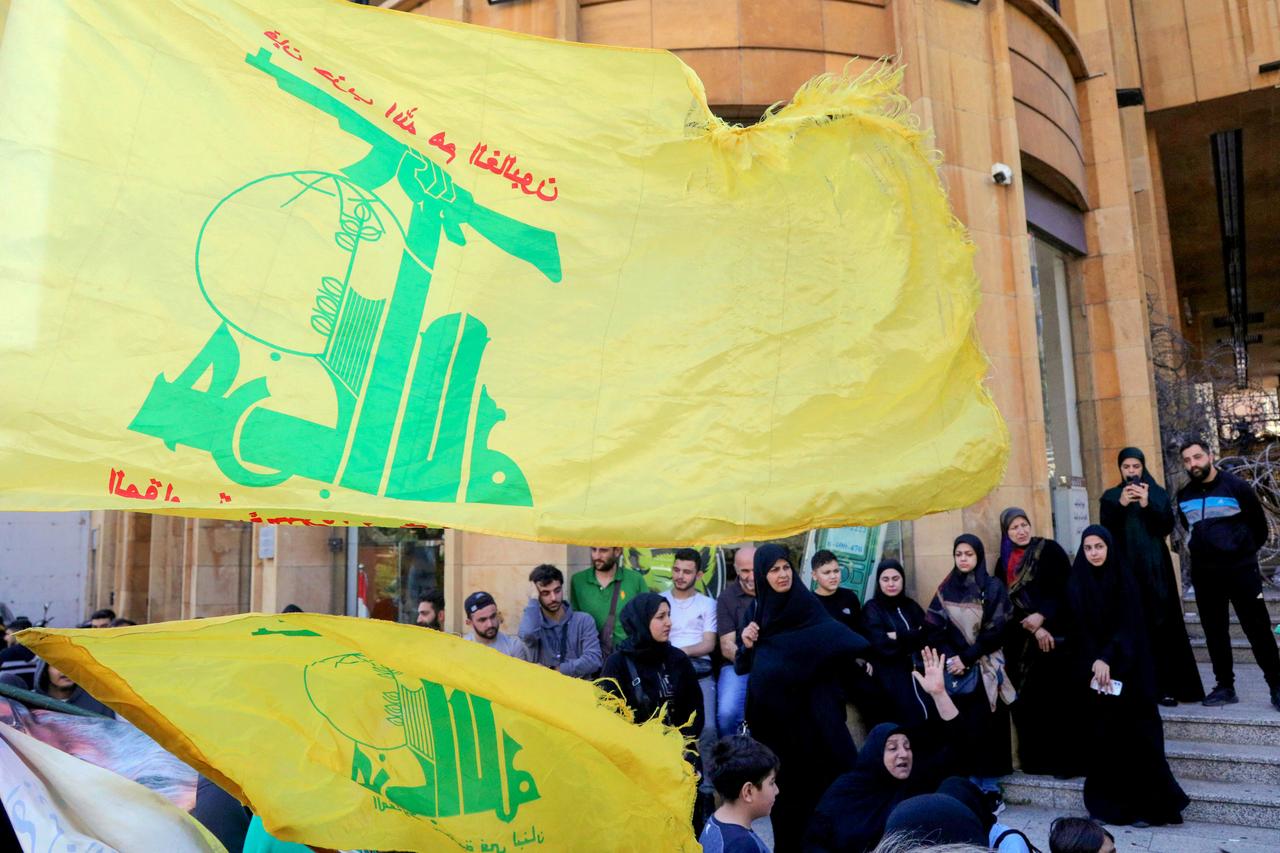 Hezbollah supporters wave flags as they stage an anti-government protest outside the Lebanese governmental palace in Beirut on April 9, 2026. (AFP Photo)