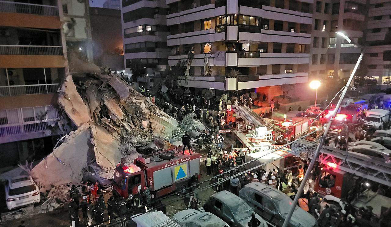 First responders and residents gather at the site of an Israeli airstrike in Beirut's Tallet al-Khayyat neighborhood, on April 8, 2026. (AFP Photo)
