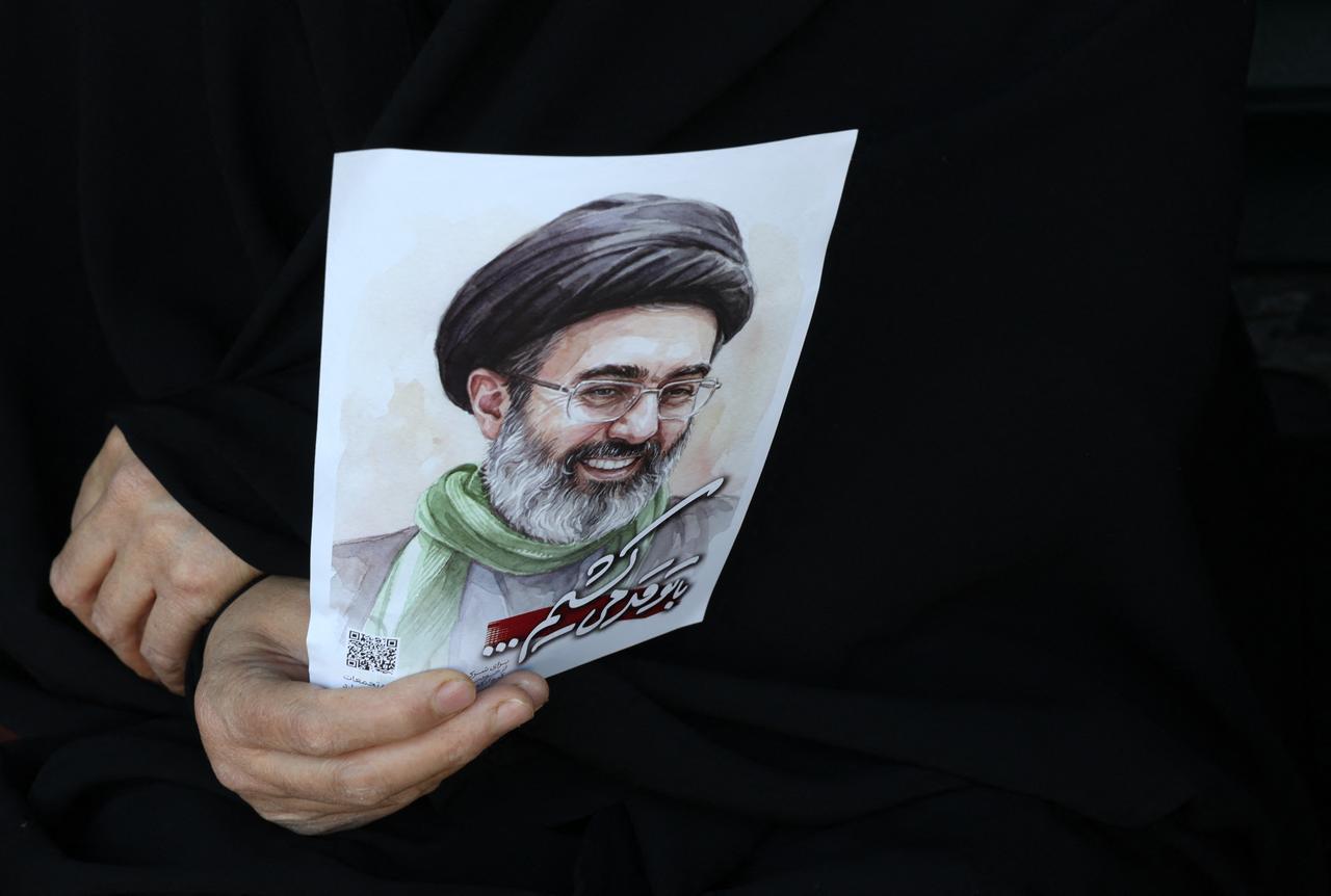 A woman holds a portrait of Iran's supreme leader, Mojtaba Khamenei, during a rally to commemorate the death of his father, Iran's slain supreme leader Ali Khamenei, in Tehran on April 9, 2026. (AFP Photo)