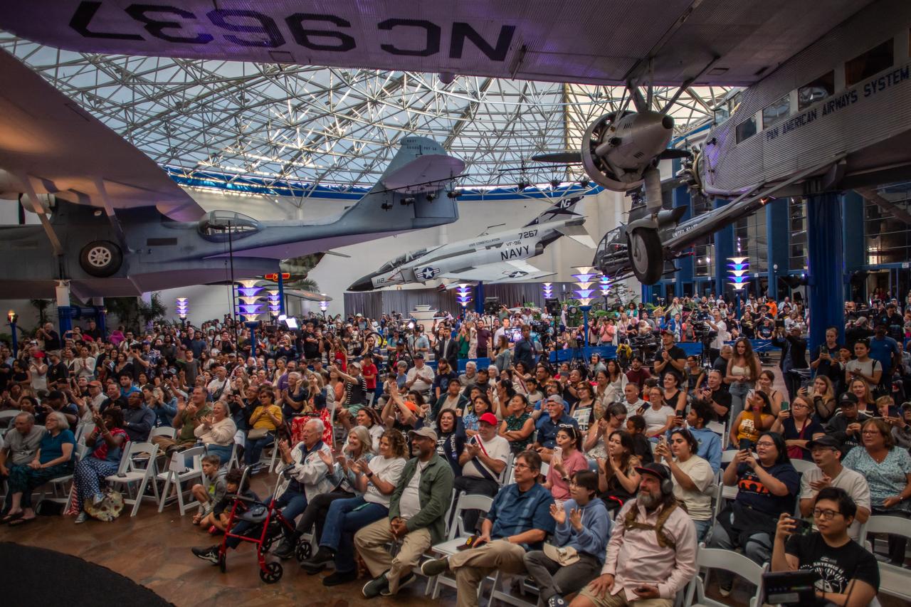 People celebrate as they watch a live broadcast of the return of the Artemis II crew members to Earth at the San Diego Air and Space Museum during a watch party for the crew's splash down in the Pacific Ocean, in San Diego, California, on April 10, 2026. (AFP Photo)