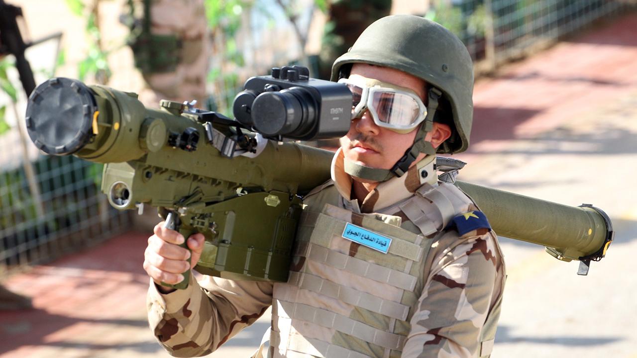 A member of the Iraqi army carries a man-portable air-defense system (MANPAD) as he stands on a vehicle during a yearly military parade on February 1, 2015, in the capital Baghdad. (AFP Photo)