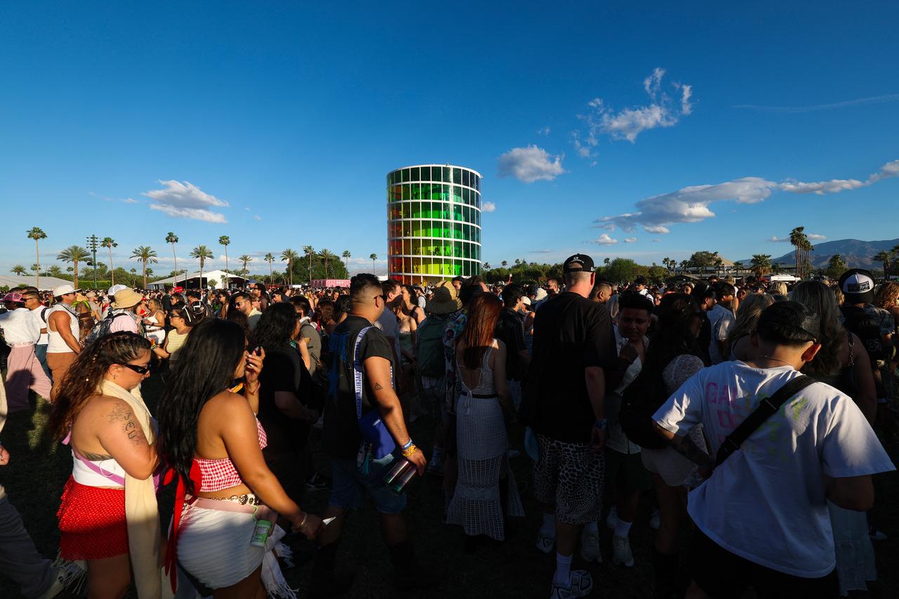 Festival-goers walk past the “Spectra” tower designed by UK-based studio Newsubstance during the 2026 Coachella Valley Music and Arts Festival in Indio, California, April 10, 2026. (AFP Photo)