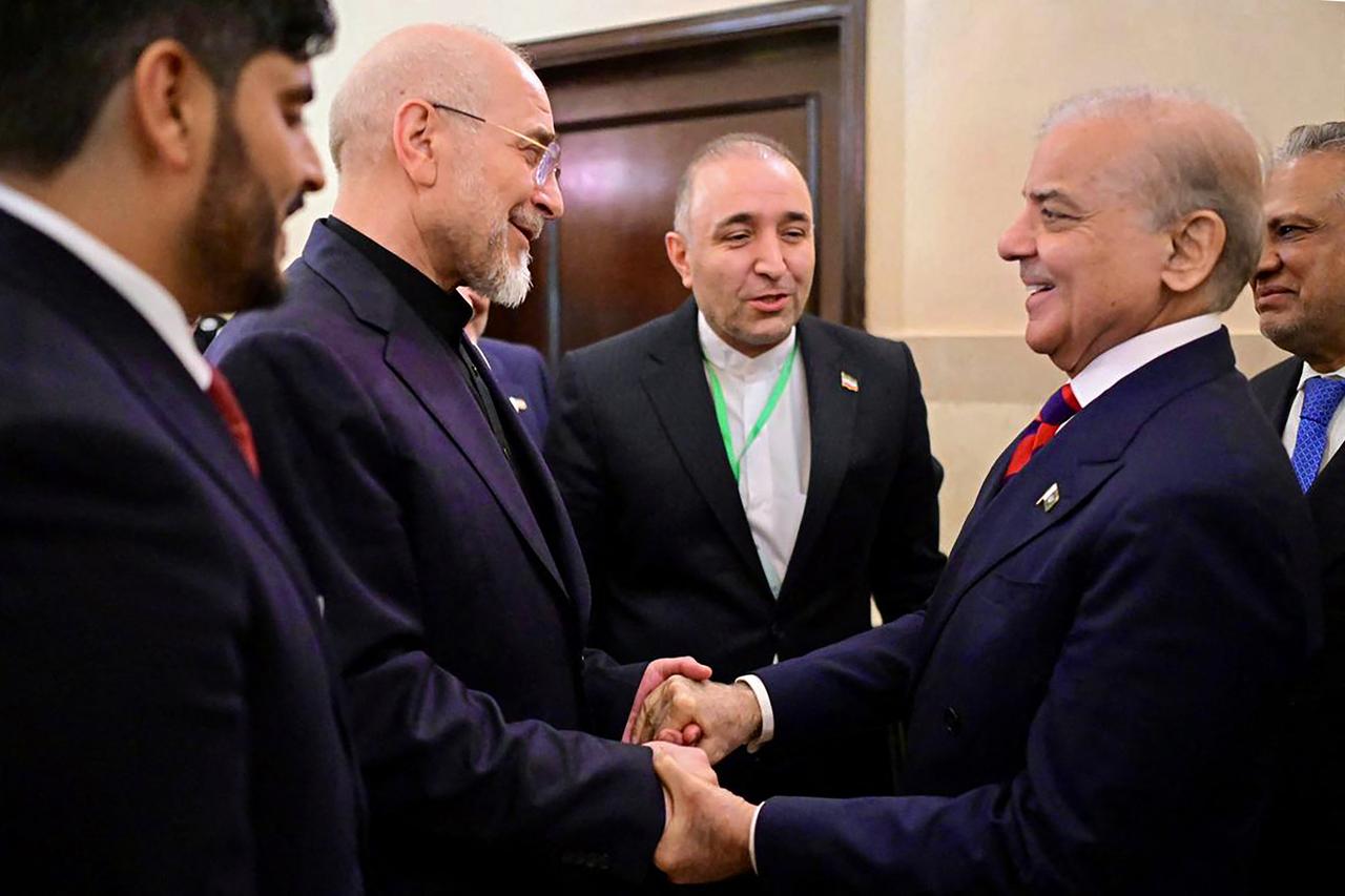 This handout photograph, taken on April 11, 2026, shows Pakistan's Prime Minister Shehbaz Sharif (2R) with Foreign Minister Ishaq Dar (R) greeting Iran's parliamentary speaker Mohammad Bagher Ghalibaf (2L) during their meeting prior to the US-Iran peace talks in Islamabad. (Photo by Pakistan Prime Minister's Office/AFP)