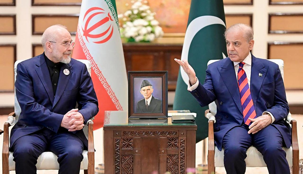 This handout photograph taken on April 11, 2026 shows Pakistan's Prime Minister Shehbaz Sharif (R) speaking with Iran's parliamentary speaker Mohammad Bagher Ghalibaf during their meeting prior to the US-Iran peace talks in Islamabad. (Photo by Pakistan Prime Minister's Office/AFP)