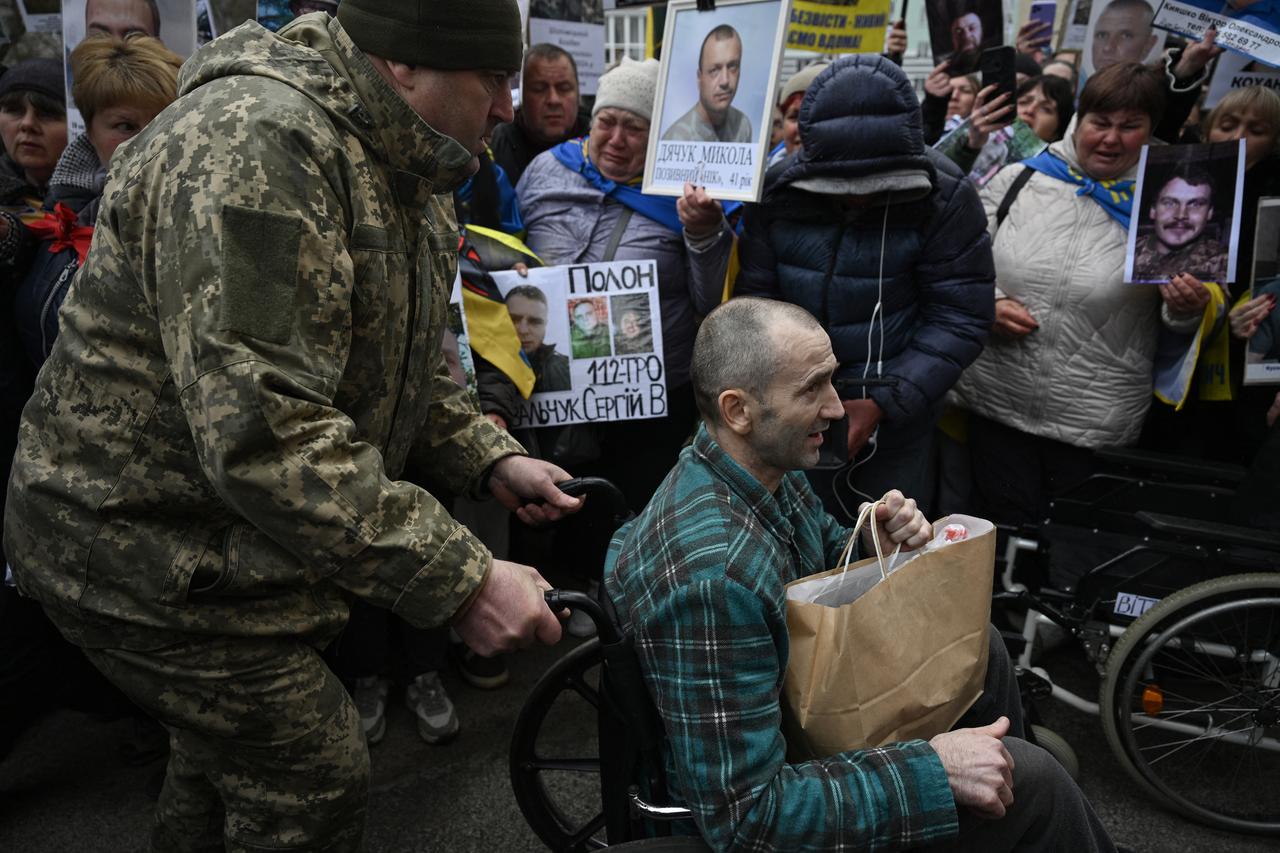 A released Ukrainian prisoner of war (POW) is pushed in a wheelchair after being swapped in a prisoner exchange in the Chernihiv region on April 11, 2026. (AFP Photo)